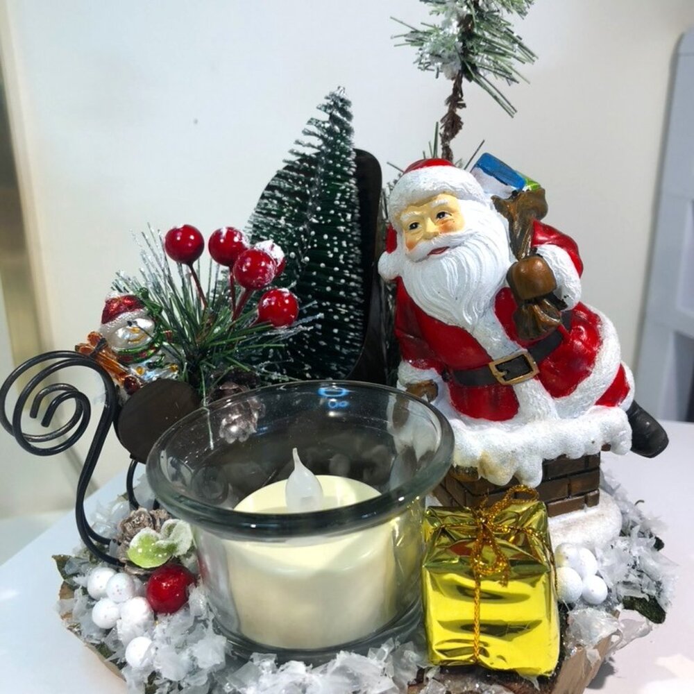 Handmade holiday candle holder features Santa Claus.